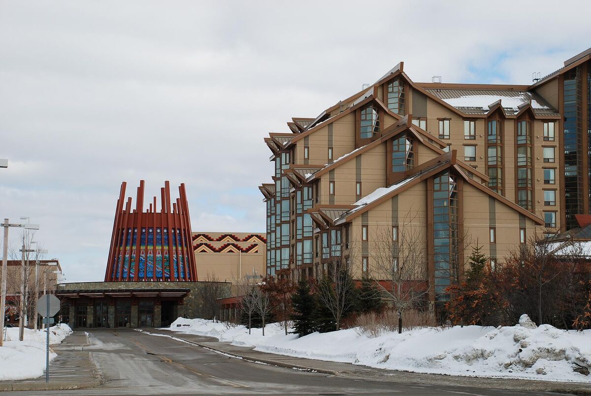 Casino Rama hotel tower and entrance with a tall decorated cylindrical structure, snow on the ground