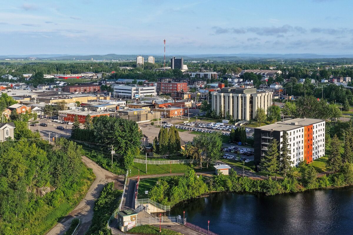 Aerial view of downtown Jonquière in Saguenay with low buildings, trees and the Rivière aux Sables