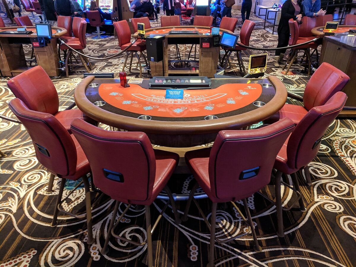 A blackjack table with cards and chips.