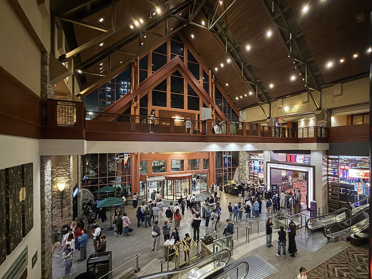 The busy multi-level lobby of River Rock Casino Resort with wood beams and escalators