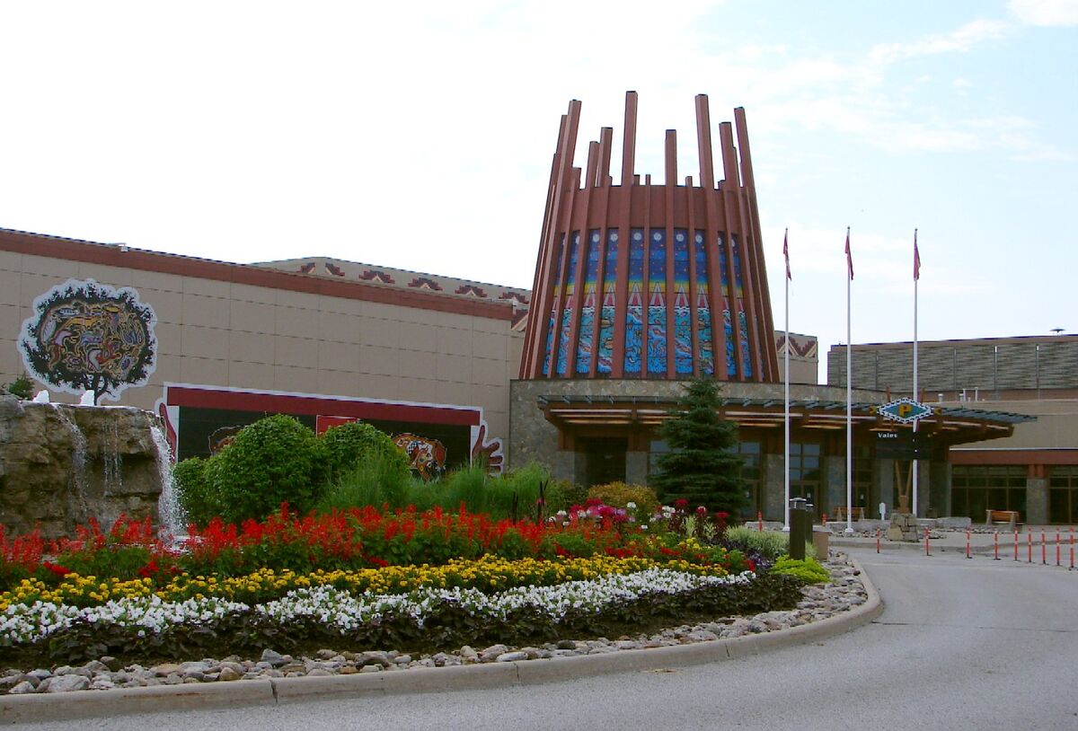 Entrance of Casino Rama with a tall decorative tower and flower beds