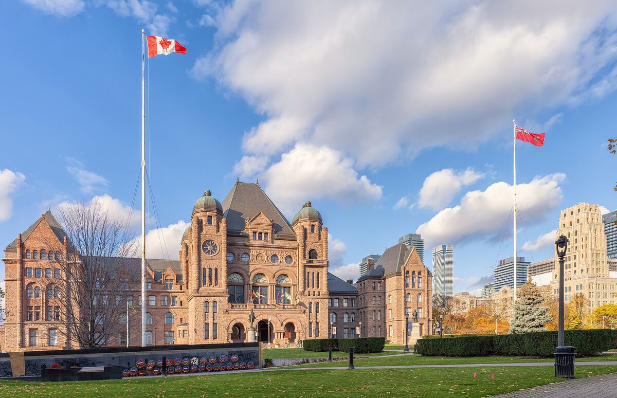 The Ontario Legislative Building at Queen's Park in Toronto under a blue sky