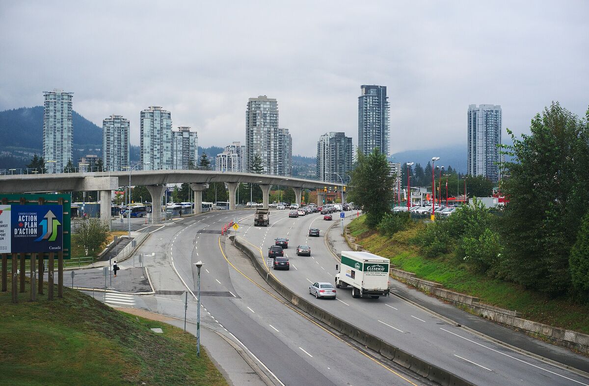 Lougheed Highway in Coquitlam with an elevated SkyTrain guideway and high-rise towers