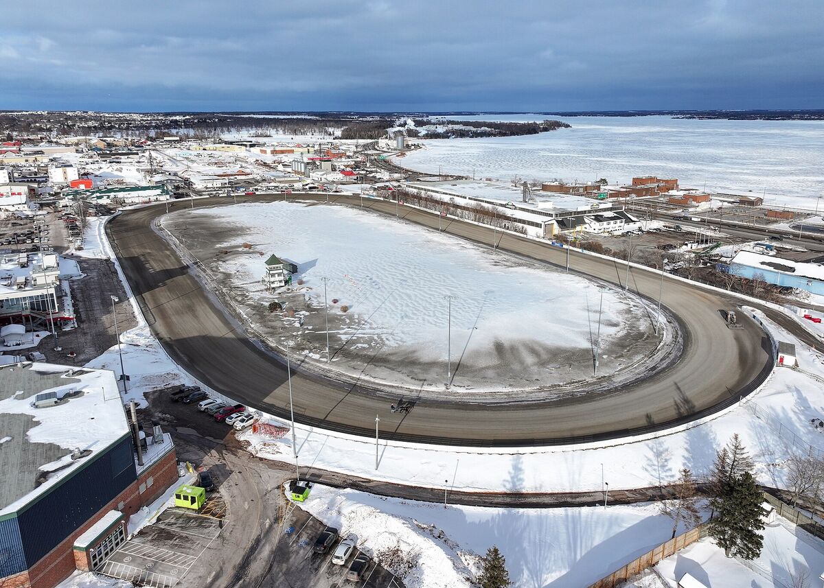 Aerial winter view of the oval harness racing track at Red Shores in Charlottetown, with the harbour beyond