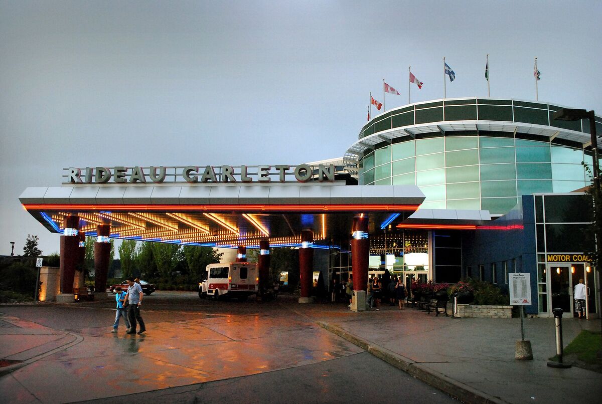 Lit entrance canopy with Rideau Carleton lettering at dusk